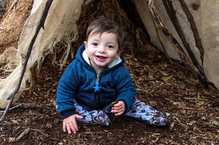 smiling baby under tree