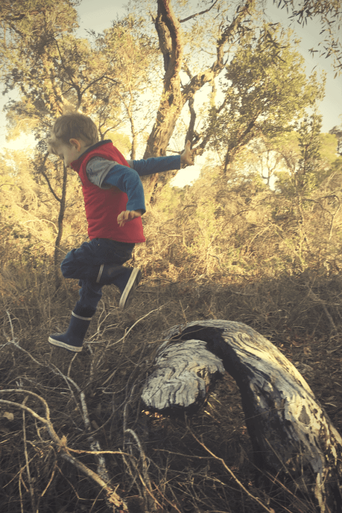 boy jumping off rock