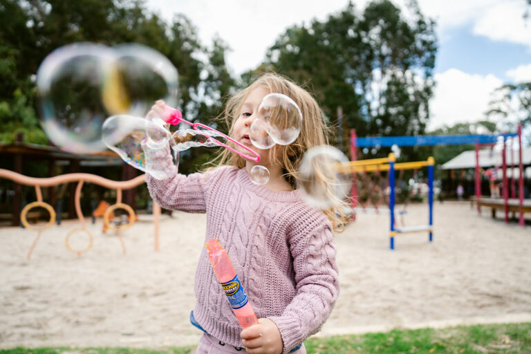 Blowing bubbles in the playground