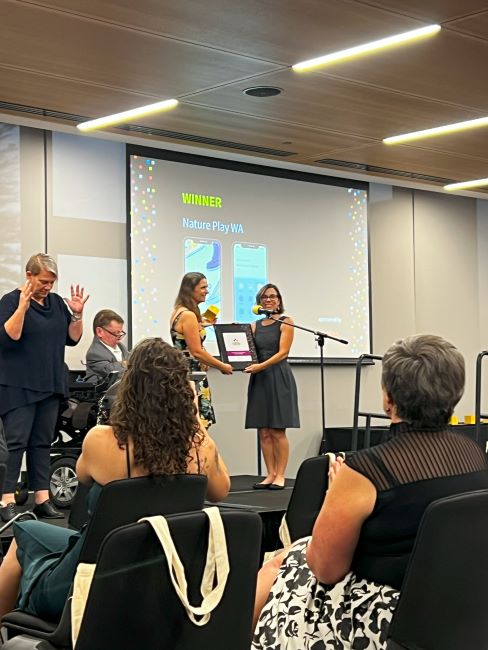Dr Kelsie Prabawa-Sear accepts Nature Play WA's award from Justin Brown and Michelle O'Brien.