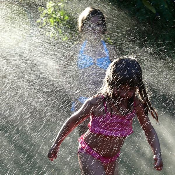 Kids playing in sprinkler