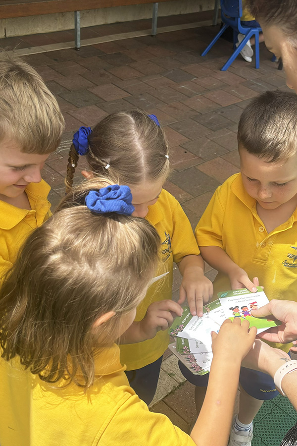 Teacher helping children choose a Nature and Me Card
