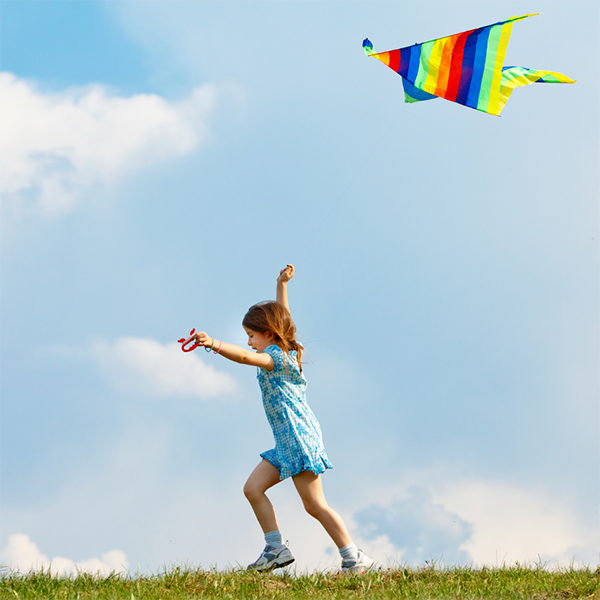 girl running with kite