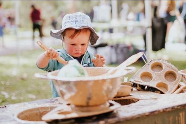 Baby playing in nature mud play