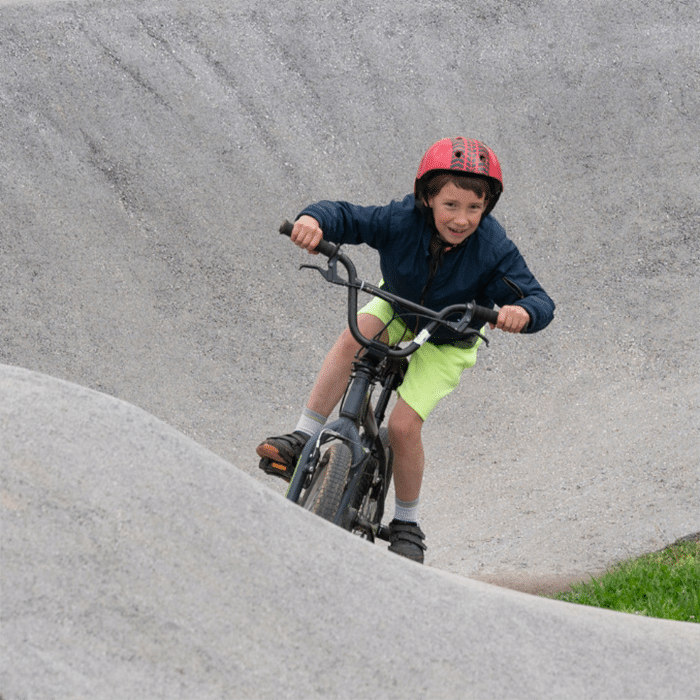 Boy riding bike on bike track