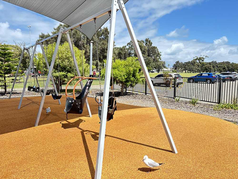 Koolaanga Waabiny Playground swings in fenced playground