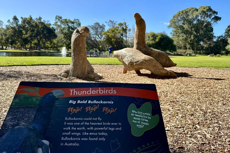 playable dinosaur sculpture and signage